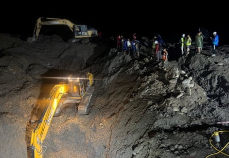 Rescuers use diggers on Monday to clear way to a tunnel of the Trishuli 3A Hydropower project, following deadly flash floods and a mudslide, in Nuwakot district, Nepal.