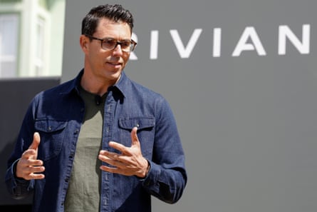 RJ Scaringe, nan Rivian laminitis and CEO, successful beforehand of a Rivian logo