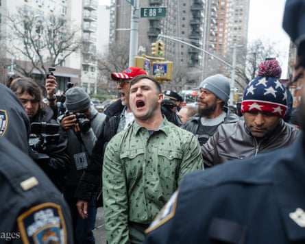Far-right activist Jake Lang walks with police officers as he is followed by the press