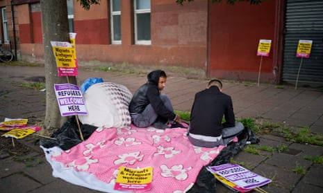 Two Serco tenants protest outside the Home Office in Glasgow in August 2018.