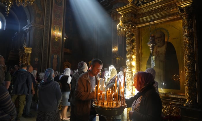 People lit candles in memory of people killed by Russian shelling last Thursday, in the Orthodox church in Vinnytsia, Ukraine, Sunday, July 17, 2022. Russian missiles struck the city of Vinnytsia in central Ukraine on Thursday, killing at least 23 people and injuring more than 100 others, Ukrainian officials said.