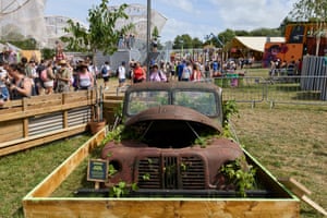 A rusting car in a planter box