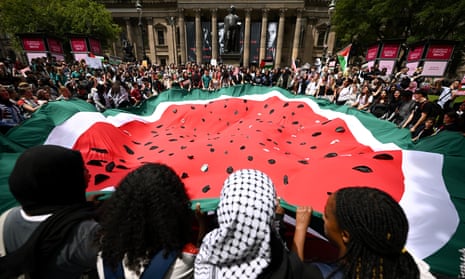 Students unfurl a Palestinian flag in the shape of a watermelon – a symbol of solidarity with Palestinians – in Melbourne.