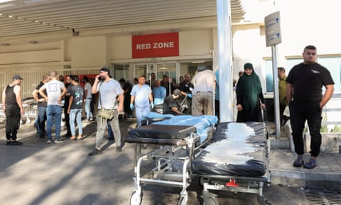 People gather outside a hospital as hundreds of members of the Lebanese armed group Hezbollah were seriously wounded.