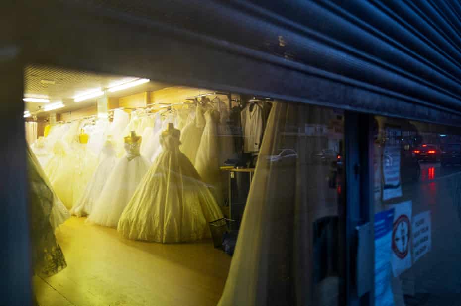 Wedding dresses in a closed shop, London, 1 March
