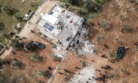 An aerial view of wreckages around the site after an operation carried out by US forces with the support of an F-16 fighter jet and a helicopter in Idlib, Syria.