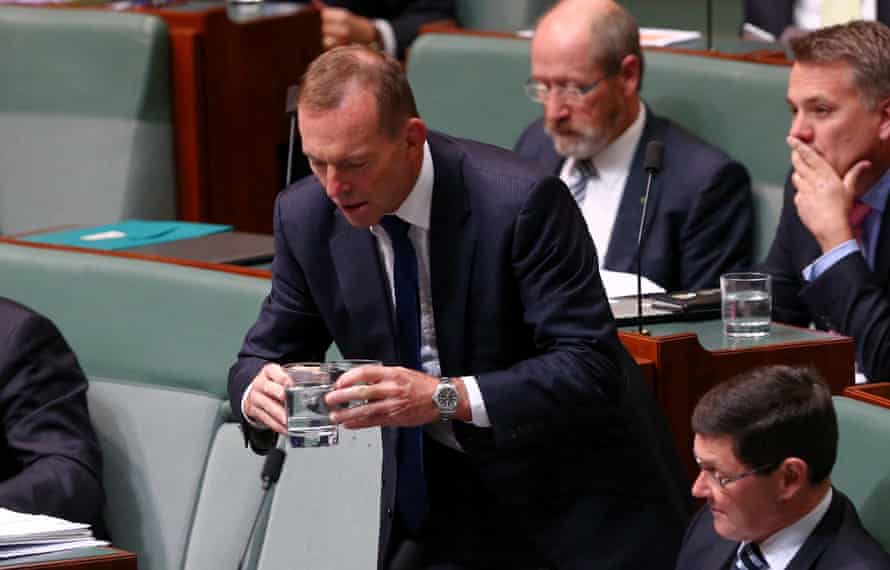 Tony Abbott spills some water while getting it for his colleagues Andrew Robb and Kevin Andrews during question time in the House of Representatives in Canberra this afternoon, Tuesday 19th April 2016.