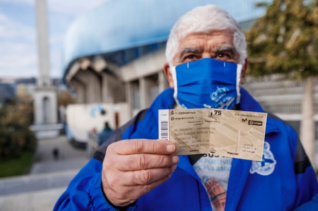 A fan proudly shows of his ticket for the game.