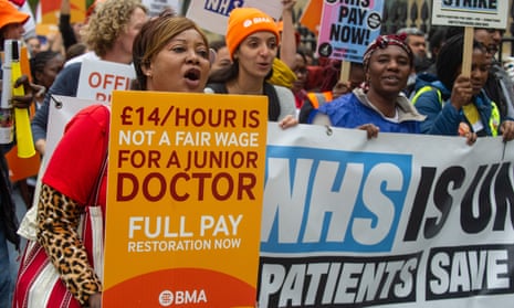 NHS consultants and junior doctors hold placards and shout slogans on the picket line in central London in September over pay grievances.