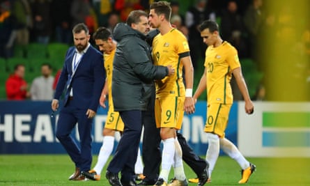Coach Ange Postecoglou with Tomas Juric as the Australian players leave the field in Melbourne, unsure of their World Cup qualifying fate.