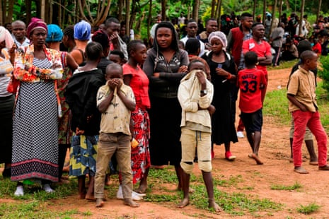 People gather in the Congolese city of Oicha for the burial of victims of the latest massacre in the country’s volatile eastern area