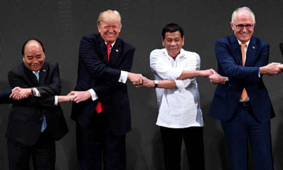 Nguyen Xuan Phuc, Donald Trump, Rodrigo Duterte and Malcolm Turnbull link hands during the opening ceremony of the Asean summit