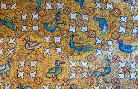 Closeup of peacocks on a wall mosaic