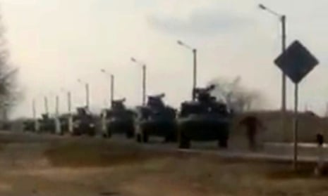 A still from the video of a man standing in front of a Russian military convoy.