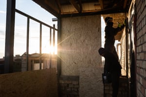 Minor Almazbek and his brother cover the veranda with wood in Sary-Mogol.