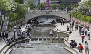 People gather at the Cheonggye stream on Thursday as daily life slowly returns to normal amid a lifting of restrictions in the wake of the coronavirus pandemic in Seoul, South Korea.