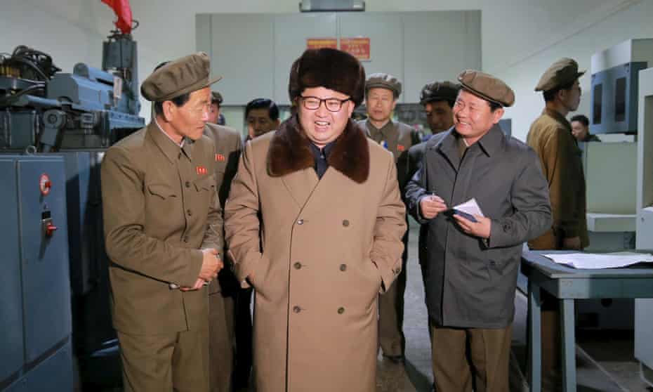 Leader Kim Jong-un smiles during a visit to the Sinhung Machine Plant in Pyongyang.