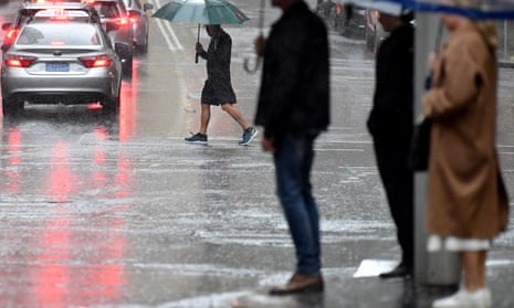 People shelter under umbrellas in Sydney on Thursday amid wild weather. The Bureau of Meteorology said much of NSW would see showers and isolated thunderstorms developing on Thursday afternoon.