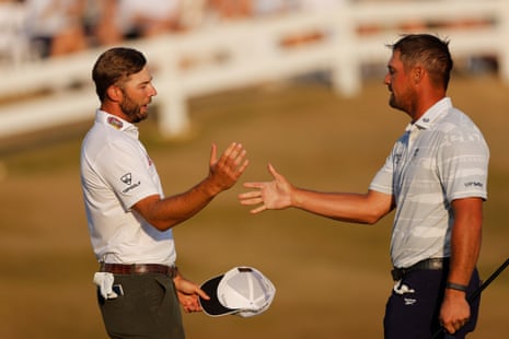 Sam Burns shakes hands with Bryson DeChambeau.