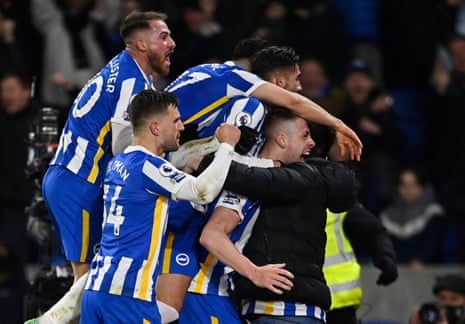 Brighton &amp; Hove Albion’s Adam Webster celebrates scoring their equaliser with team-mates and fans.