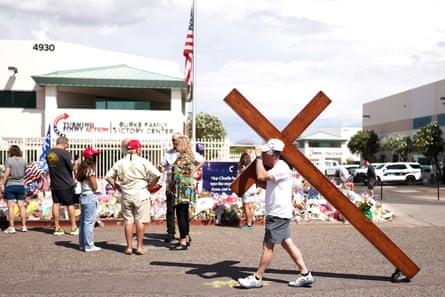 A man wheels a cross