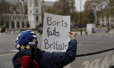 An anti-Brexit protester holds a placard after Boris Johnson drove past to attend prime minister’s questions