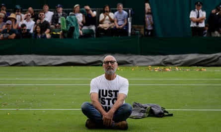 A Just Stop Oil protester sits on Court 18 on day three of the Wimbledon Championships