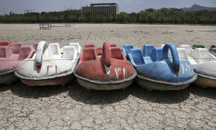 A row of paddle boats sit on the parched Zayandeh Roud riverbed, in Isfahan, Iran.