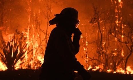 NSW Rural Fire Service crews protect properties as the fire approaches Mangrove Mountain north of Sydney.