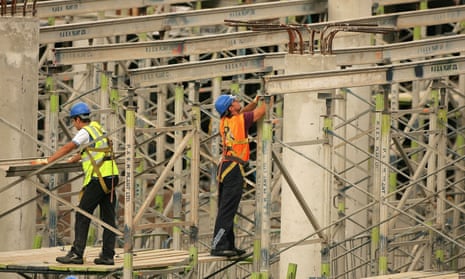 Construction men work on a shopping centre