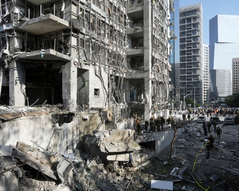 Rescue workers and military personnel inspect the site of a direct hit from an Iranian missile strike in Ramat Gan
