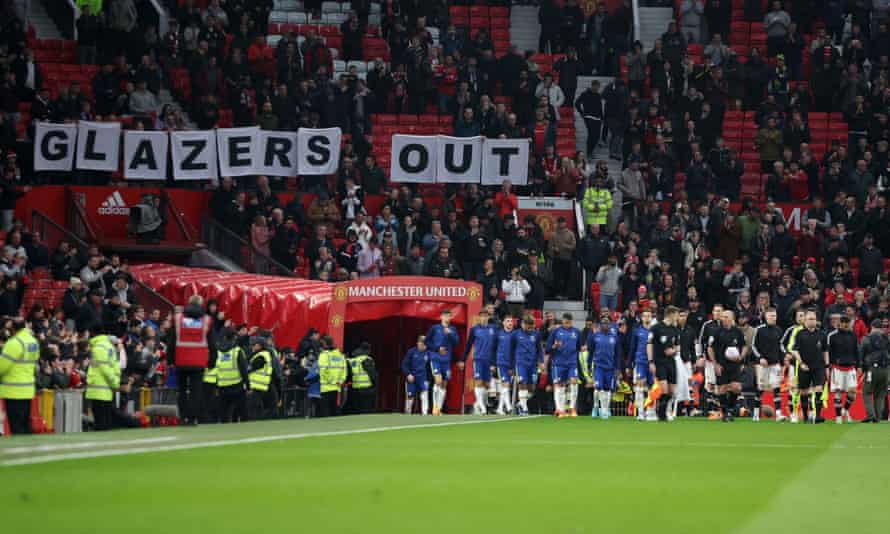 The teams go out at Old Trafford while Manchester United fans protest the Glazer family's ownership of the club.