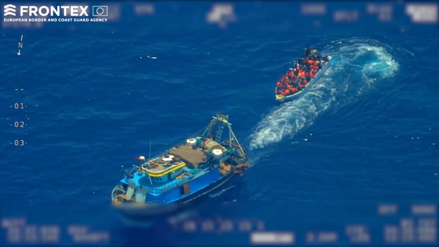 A screengrab taken from an undated video from Frontex shows a fishing trawler pulling away from a wooden boat with refugees and migrants onboard