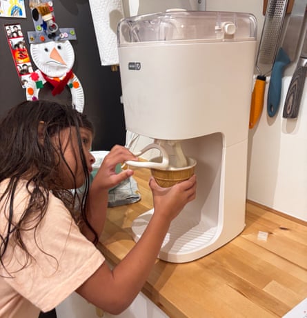 A child dispensing soft serve from a Dash Soft Serve Ice Cream Machine