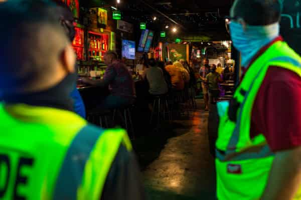 Code enforcement inspectors Paul Navarro (eft) and Troy Montero make sure that local business employees wear protective face masks in Key West on 18 September.