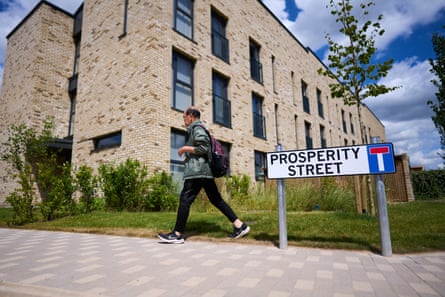 A street sign that reads Prosperity Street, with a row of new homes behind it