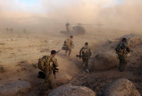 Special Operations Task Group soldiers make their way to a waiting UH-60 Blackhawk helicopter in Sha Wali Kot, Afghanistan.