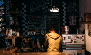 A worker at the Ogonek cafe in St Petersburg makes tea at the counter.