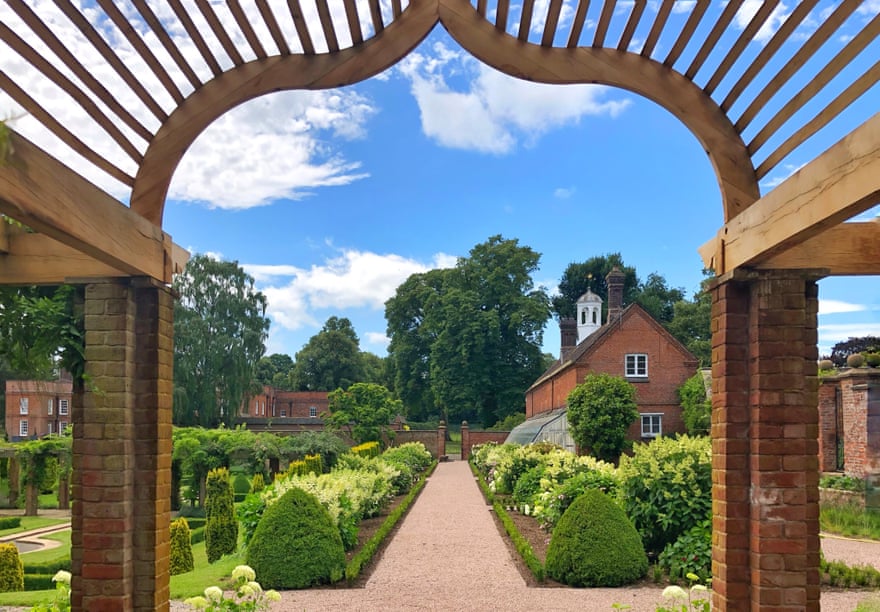 A view through an arch to a walled garden in Peplow Estate.