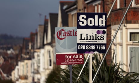 Estate agents' signs outside houses
