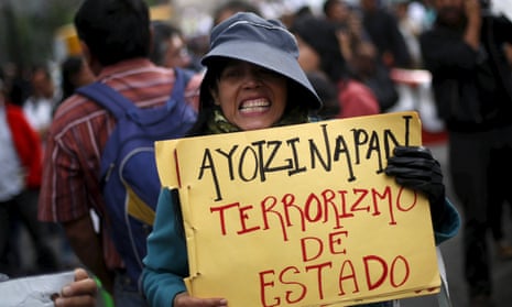 A demonstrator holds a sign during a march to protest against the government’s handling of the investigation in the case of missing students in Mexico City last month.