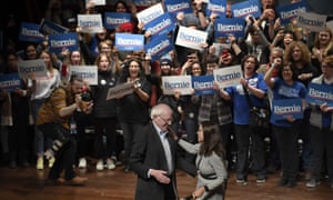 Bernie Sanders is greeted by Alexandria Ocasio-Cortez during a rally in Ames, Iowa, on 25 January.