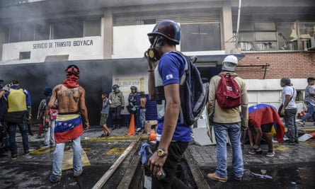 Anti-government activists set a police station ablaze in Caracas