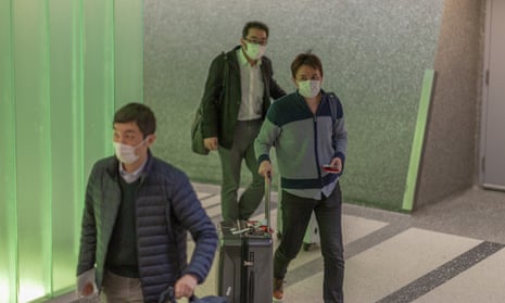  Travelers arrive to the Los Angeles airport wearing medical masks for protection against the coronavirus outbreak on 2 February 2020.