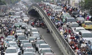 Commuters are seen during rush hour on a street in Hanoi