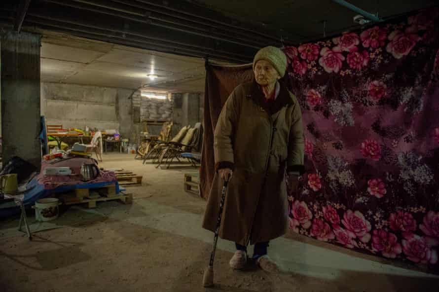 A Ukrainian senior citizen stands with the help of a walking stick at a shelter in northern Kharkiv, Ukraine.