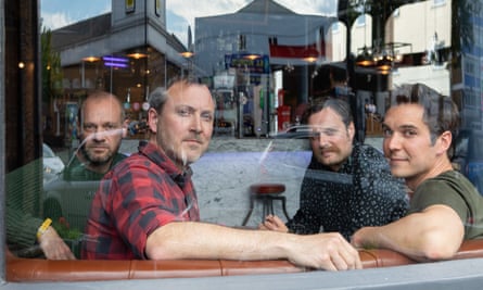 Four Led By Donkeys activists seen through a pub window