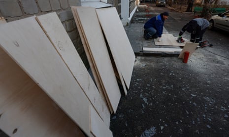 Municipal workers prepare plywood for for boarding up broken windows after shelling in downtown Donetsk, Ukraine. During the last five days of shelling, 11 people were killed and 25 injured.