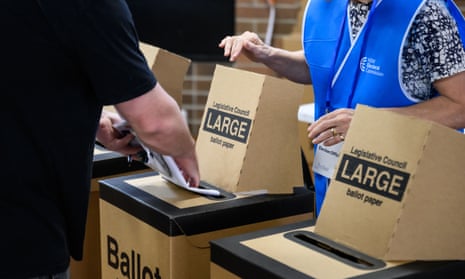 A person places their vote in the ballot box