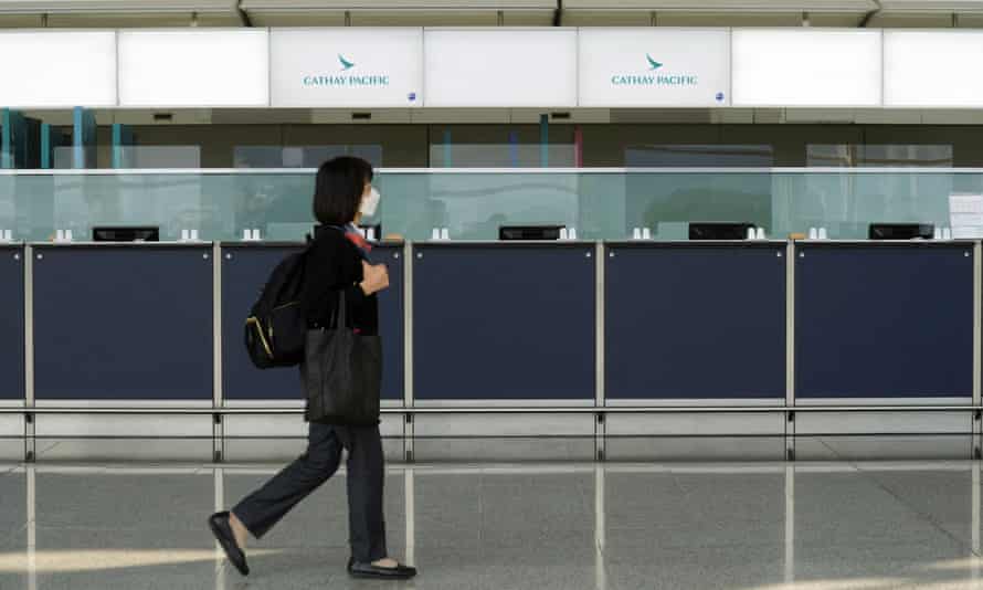 A woman walks past empty counters of Cathay Pacific at Hong Kong international airport in January 2022.